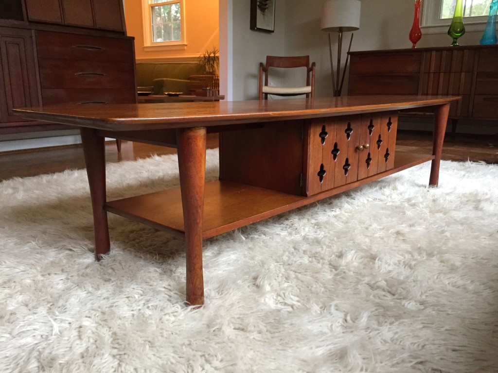 mid century modern walnut surfboard coffee table with cabinet and shelving
