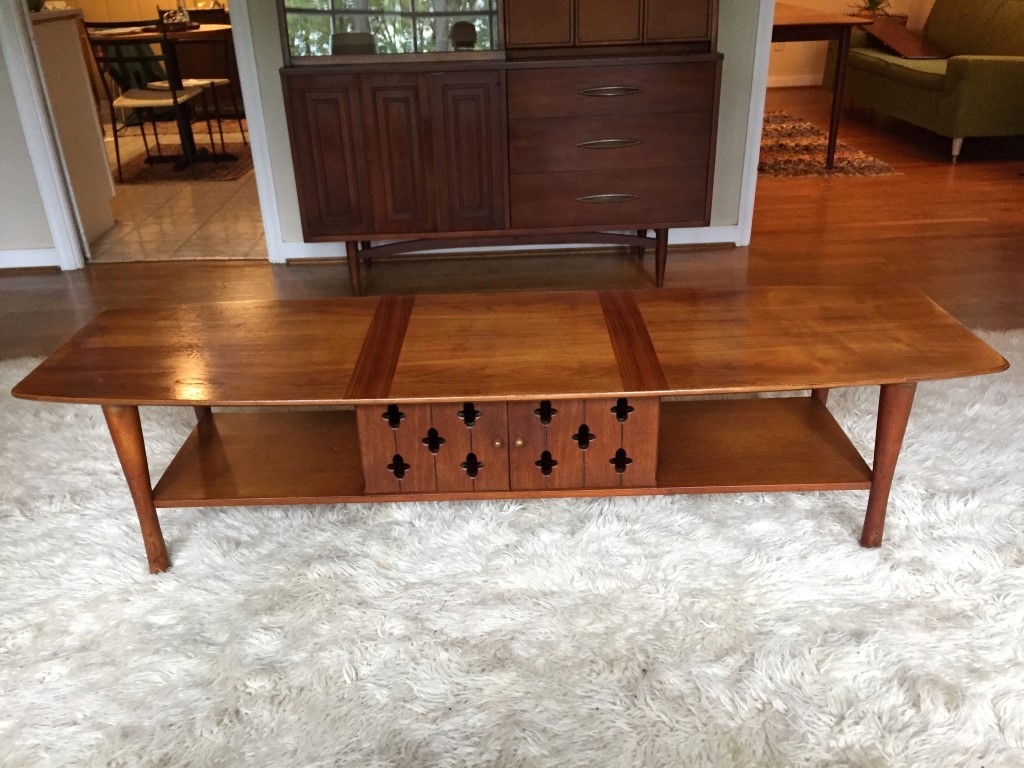mid century modern walnut surfboard coffee table with cabinet and shelving