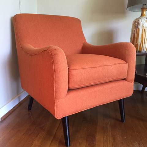 mid century style armchair in orange