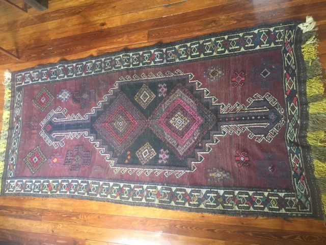 afghani tribal rug handknotted purple background